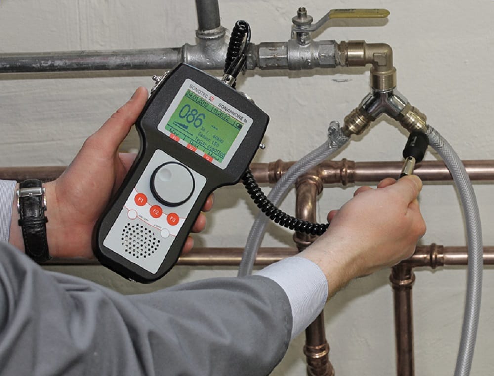 Plumber testing pipes with electronic leak detection equipment in Sun City Center