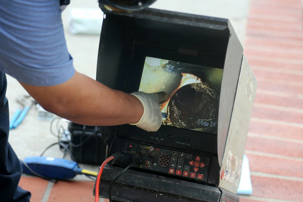 Technician viewing a drain inspection camera in Sun City Center