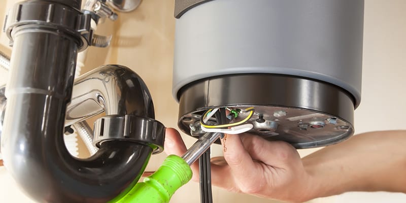 Technician repairing the heating element of a water heater in Sun City Center