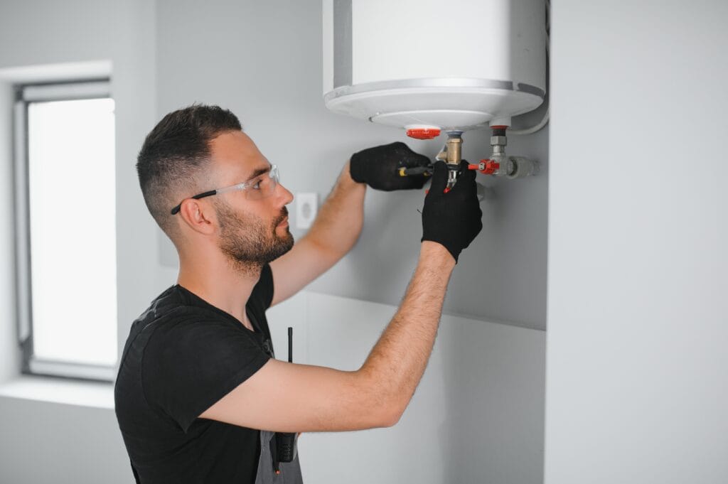 Technician performing water heater maintenance in Sun City Center