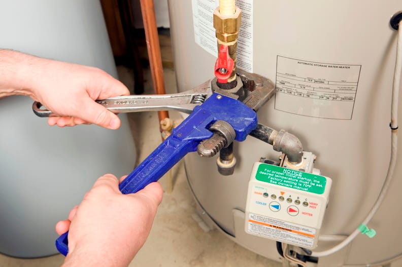 Plumber repairing a water heater valve in Sun City Center
